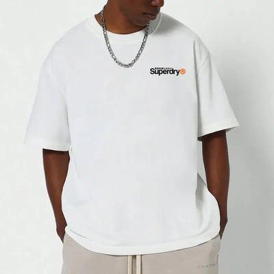 Man wearing a Superdry vintage t-shirt in white, featuring the Superdry logo on the chest and relaxed fit design.